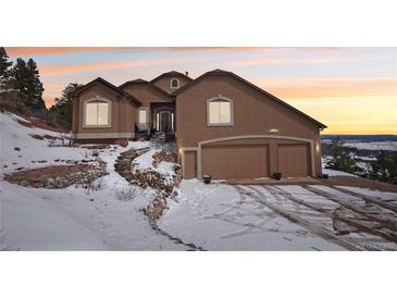 Charming home featuring an attached garage, a stone staircase, and picturesque mountain views at 13084 Deer Ridge Way, Larkspur, CO 80118
