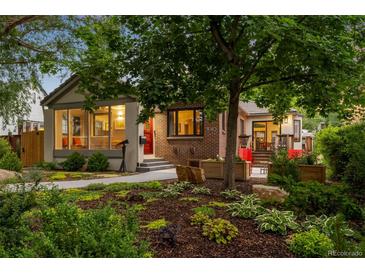 Charming home featuring a well-maintained front yard and landscaped garden at 840 S Gaylord St, Denver, CO 80209
