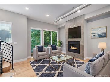 Bright living room features a modern fireplace, large windows, and stylish furnishings at 2831 W 25Th Ave # 3, Denver, CO 80211
