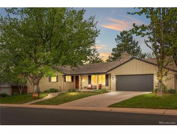 Charming single Gathering home boasts a manicured lawn, attached garage, and welcoming front porch at 3194 S Milwaukee St, Denver, CO 80210