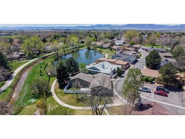 Beautiful aerial view of the community with green spaces, a pond, walking path, and mountain views at 39 S Scott Dr, Broomfield, CO 80020