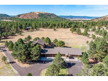 Picturesque home with attached garage nestled among towering pines with mountain views at 3842 Estates Cir, Larkspur, CO 80118