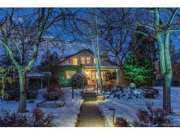 Charming two-story home with snowy landscaping and pathway at 1920 Oneida St, Denver, CO 80220