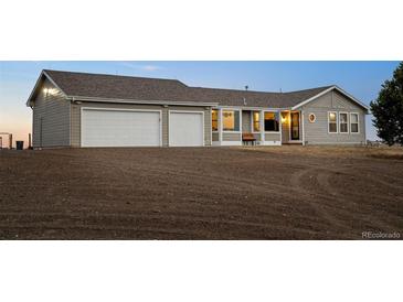 Ranch-style home featuring an attached two-car garage, neutral siding, and a well-maintained lawn at 44011 Morning Star Ct, Elizabeth, CO 80107