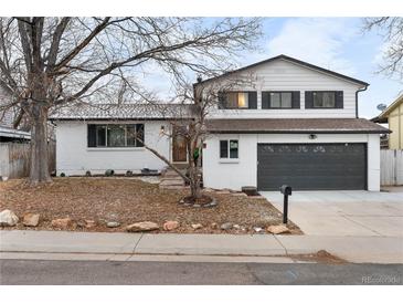 Charming home with a well-manicured front yard, showcasing its inviting curb appeal at 9565 W Lake Pl, Littleton, CO 80123