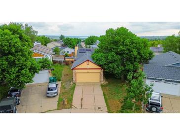 Charming single-Gathering home with well-kept lawn, mature trees, and solar panels on the roof at 7961 Jared Way, Littleton, CO 80125