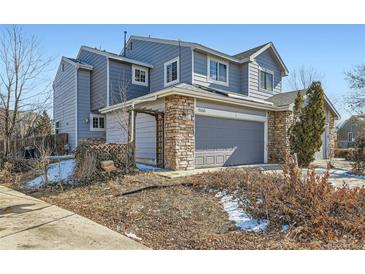 Charming two-story home features a gray facade and a convenient two-car garage at 4666 Cornish Way, Denver, CO 80239