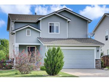 Charming two-story home featuring a two-car garage, manicured lawn and appealing curb appeal at 9595 Marmot Ridge Cir, Littleton, CO 80125