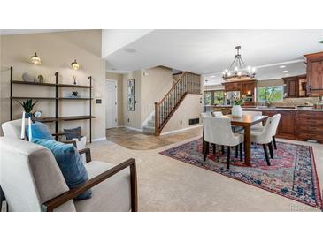 Inviting living room flows into the kitchen with natural light and a cozy seating area featuring custom shelves at 3418 Elk Ct, Broomfield, CO 80020