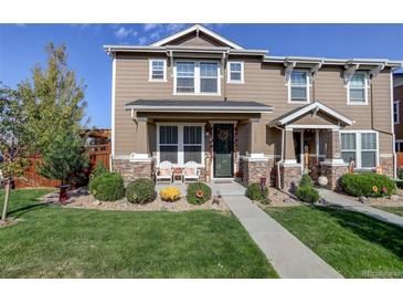 Two-story townhome with landscaped front yard and stone accents at 2388 W 165Th Pl, Broomfield, CO 80023
