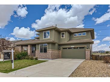 Charming two-story home with brick accents, a two car garage, and well-maintained landscaping at 4406 Sidewinder Loop, Castle Rock, CO 80108