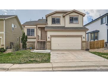 Charming two-story home with a two-car garage, a cozy entrance, and landscaped front yard at 20112 E Grand Pl, Aurora, CO 80015