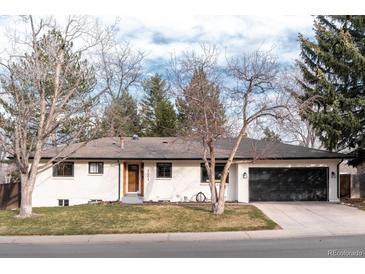 Charming single-story home featuring a well-maintained lawn and an attached two-car garage at 3004 S Niagara Way, Denver, CO 80224