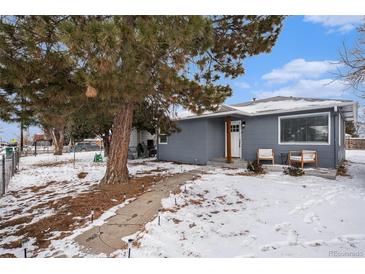 Charming gray house with snowy front yard, walkway, and landscaping at 1280 Macon St, Aurora, CO 80010