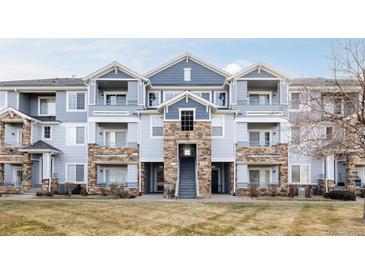 Inviting three-story building with stone accents and landscaping at 5255 Memphis St # 822, Denver, CO 80239