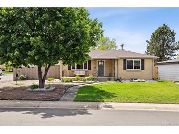 Charming ranch-style home with manicured lawn, mature tree, and inviting front porch at 4780 E Montana Pl, Denver, CO 80222