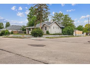 Charming corner lot home featuring a classic design, mature trees and lush landscaping at 4001 S Acoma St, Englewood, CO 80110