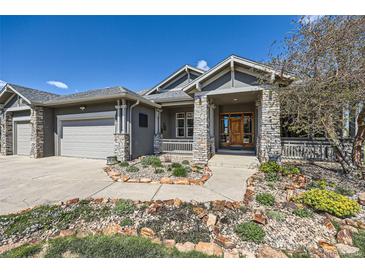 Charming home with stone accents, well-maintained landscaping, and a welcoming front porch at 4781 Mariposa Rd, Castle Rock, CO 80104