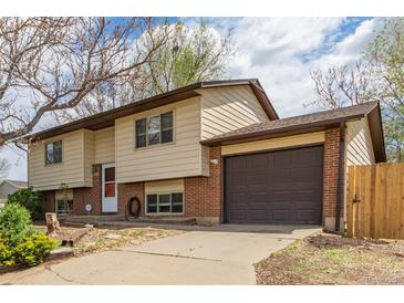 Charming two-story home featuring brick accents, a well-maintained lawn, and an attached two-car garage at 778 2Nd St, Firestone, CO 80520