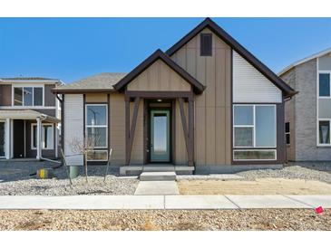 Charming single-Gathering home featuring a modern design with a well-manicured front yard and inviting entrance at 2277 Serenidad St, Brighton, CO 80601