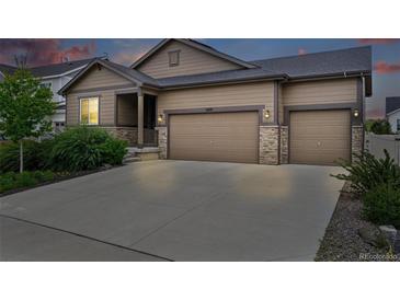 Charming single-Gathering home features a three car garage, stone accents, and well-manicured landscaping at 5670 Pinto Valley St, Parker, CO 80134