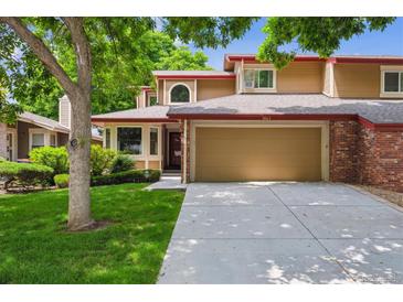 Charming two-story home with a well-maintained lawn and attached two-car garage at 8563 Redstone St, Highlands Ranch, CO 80126