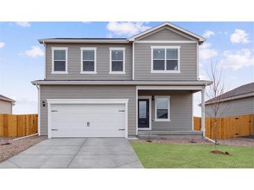 Charming two-story home with a manicured lawn, attached two-car garage and welcoming covered porch at 2134 Alyssa St, Fort Lupton, CO 80621