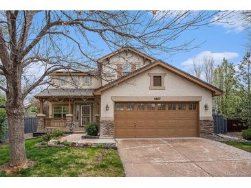 Charming two-story home with a two car garage and a covered front porch at 5607 S Gray St, Littleton, CO 80123