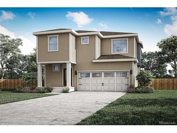 Two-story house with beige siding, two-car garage, and landscaped yard at 18328 E 93Rd Pl, Commerce City, CO 80022