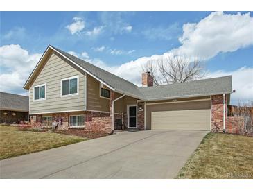 Charming two-story home with attached garage and well-maintained lawn at 7949 W Portland Ave, Littleton, CO 80128