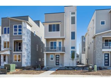 Contemporary three-story home boasting modern design and a welcoming entrance at 1243 Rhett Dr, Erie, CO 80026