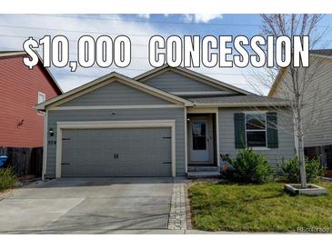 Charming single-story home with gray siding, well-maintained lawn, and an attached gray two-car garage at 370 Mesa Ave, Brighton, CO 80603