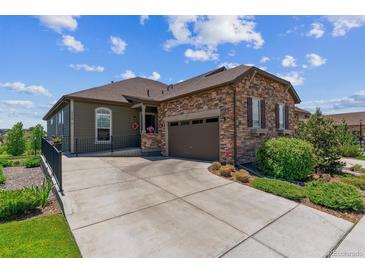 Charming single-Gathering home with a stone facade and inviting two-car attached garage at 6948 W Jewell Dr, Lakewood, CO 80227