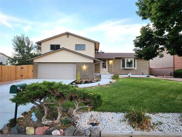 Charming two-story home with attached garage, manicured lawn, and welcoming curb appeal at 3216 S Granby Way, Aurora, CO 80014