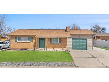 Charming single-story home with a well-maintained lawn, brick facade, and attached garage at 14441 Maxwell Pl, Denver, CO 80239