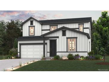 Charming two-story home with white siding, dark trim, a two-car garage and professional landscaping at 4334 Gozzer Ranch Dr, Elizabeth, CO 80107
