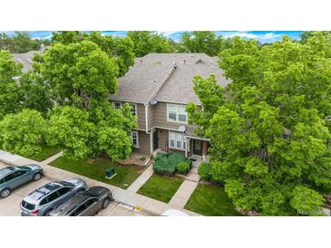 Charming two-story townhouse with lush landscaping and a well-maintained front yard, and convenient parking at 9632 W Chatfield Ave # C, Littleton, CO 80128