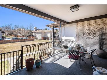 Covered patio with metal railing, room for entertaining and views of the surrounding neighborhood at 7250 Eastmoor Dr # 203, Denver, CO 80237
