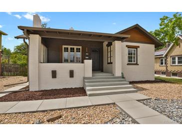 Charming bungalow with a painted brick exterior, covered porch, and well-maintained landscaping at 1455 Hudson St, Denver, CO 80220