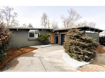 Charming single-story home with a lush, landscaped front yard and a private garage at 1459 S Filbert Way, Denver, CO 80222