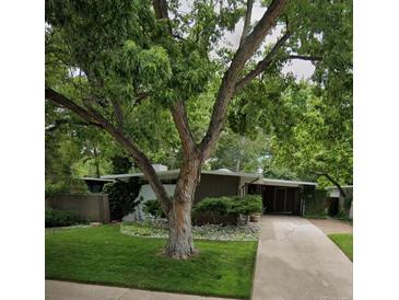 Charming single-story home with mature trees, a stone accent garden, and a welcoming entrance at 1333 S Eudora St, Denver, CO 80222