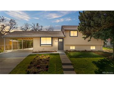 Charming single-Gathering home with a well-maintained lawn and a convenient carport at 6103 Uno St, Arvada, CO 80003