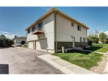 Charming two-story townhouse with a balcony, two car garage, and well-maintained lawn at 3351 S Field St # 164, Lakewood, CO 80227