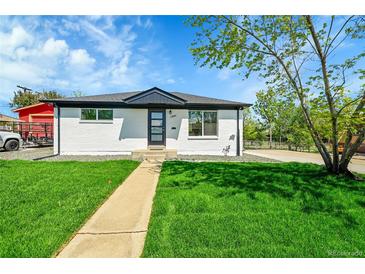 Charming single story home with a well-manicured lawn and inviting walkway at 7634 Navajo St, Denver, CO 80221