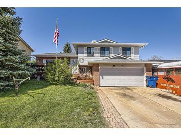 Charming two-story home with brick accents, an attached two-car garage and well-manicured lawn at 4845 S Taft St, Morrison, CO 80465