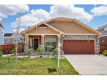Charming single-Gathering home with manicured lawn, stone accents, and a two-car garage at 464 N Jamestown Way, Aurora, CO 80018