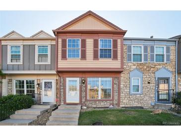 Charming townhome with a stone facade, complemented by colorful accents and a well-maintained lawn at 2991 W 81St Ave # G, Westminster, CO 80031