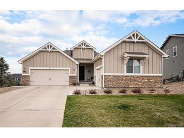 Charming single-Gathering home with a beige exterior, stone accents, and a well-maintained front yard at 42363 Glen Abbey Dr, Elizabeth, CO 80107