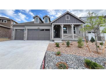 Charming gray two-story home featuring a two-car garage and welcoming front porch at 3991 Descent St, Castle Rock, CO 80108