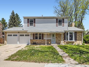 Charming two-story home featuring a well-maintained lawn and a convenient two-car garage at 14665 E Stanford Pl, Aurora, CO 80015